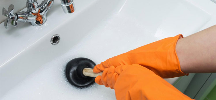 worker performing Blockage removal service in Dubai